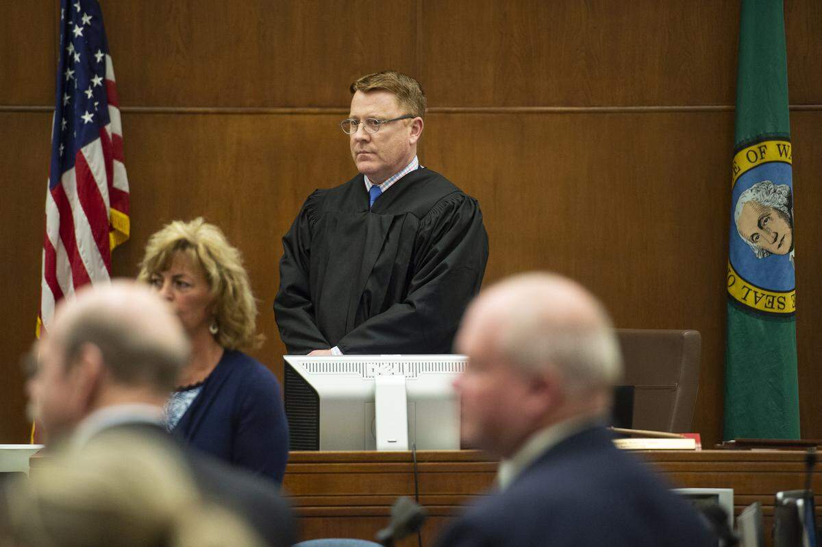 Whatcom County Superior Court Judge Rob Olson stands as the jury enters the Whatcom Superior Court in Bellingham, Wash., for the first day of Timothy Bass’ murder trial on Friday, May 10, 2019. One of the jurors was excused from the trial on Monday, May 20, due to contact with law enforcement over the weekend.