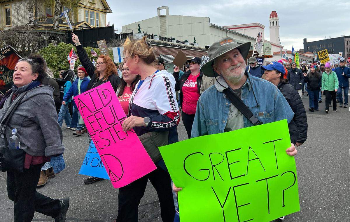 Protesters march through downtown Bellingham during a No Kings rally on March 28, 2026.
