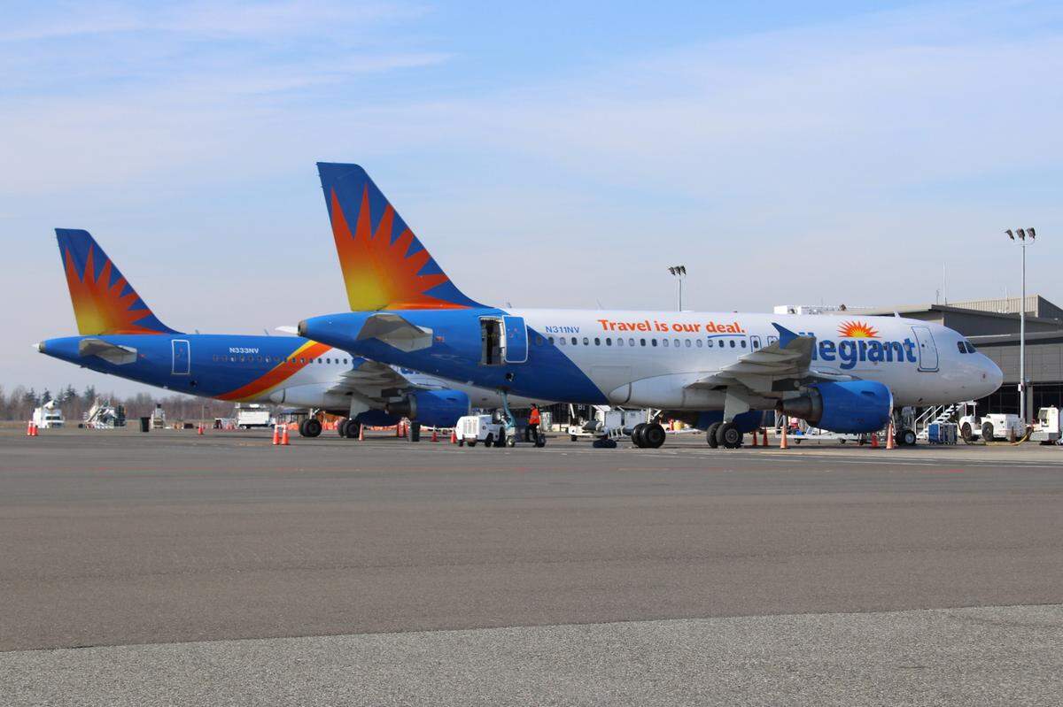 Two Allegiant Airbus 319 airliners sit on the ramp at Bellingham International Airport Thursday, March 19, 2020.