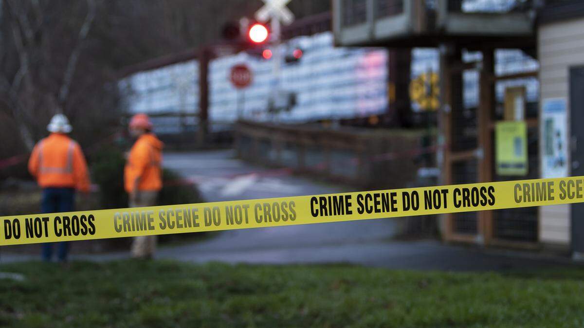 Emergency personnel stand at the north end of Boulevard Park where an unidentified pedestrian died at the South Bay Trail train crossing in Bellingham, Washington on Dec. 10, 2018.
