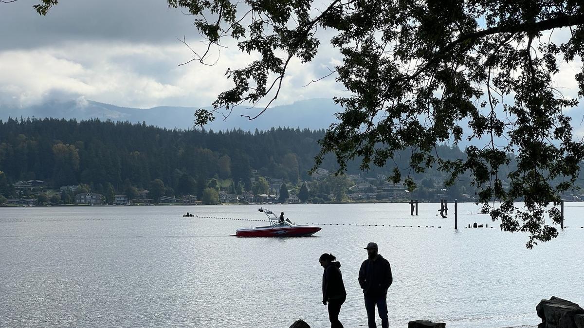 A couple and a boater enjoy Lake Whatcom at Bloedel-Donovan Park in Bellingham, Wash., on Wednesday, Sept. 18, 2024.