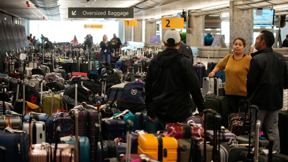 Travelers wade through unclaimed baggage near the Southwest Airlines baggage carousels at Denver International Airport, Tuesday, Dec. 27, 2022, in Denver. Thousands of Southwest flights were canceled as a winter storm and staffing shortages upended the airline, which is often one of Seattle-Tacoma International Airport’s busiest carriers.