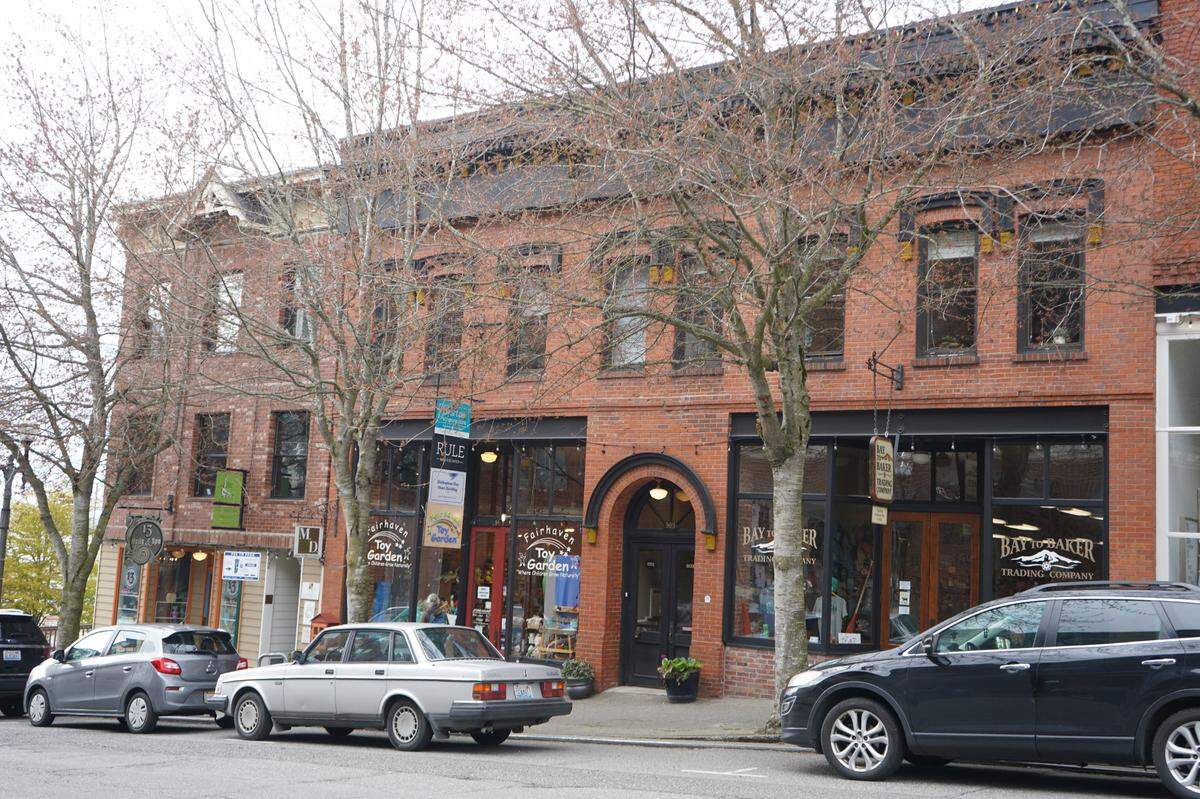 Cars are parked in front of 907-911 Harris Ave. on Thursday, April 20, 2023, in Bellingham, Wash. The two buildings were jointly listed for sale by Gage Commercial Real Estate for $3,495,000.