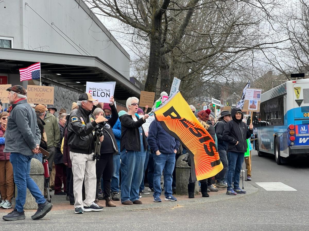 Protesters rally against the Trump administration at the corner of Cornwall Avenue and Magnolia Street in downtown Bellingham, Wash., as part of a nationwide series of protests on Tuesday, March 4, 2025.