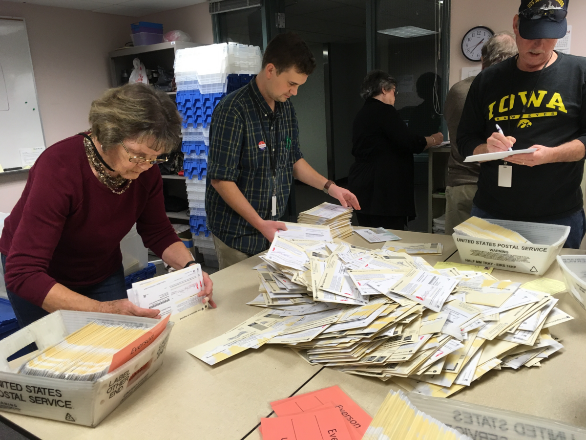 Poll workers Donna Bajema, left, Dan Broker, Tony Whitmer and Gary Small sort ballots that arrived Wednesday at the Whatcom County Auditor’s Office from drop boxes around the county.