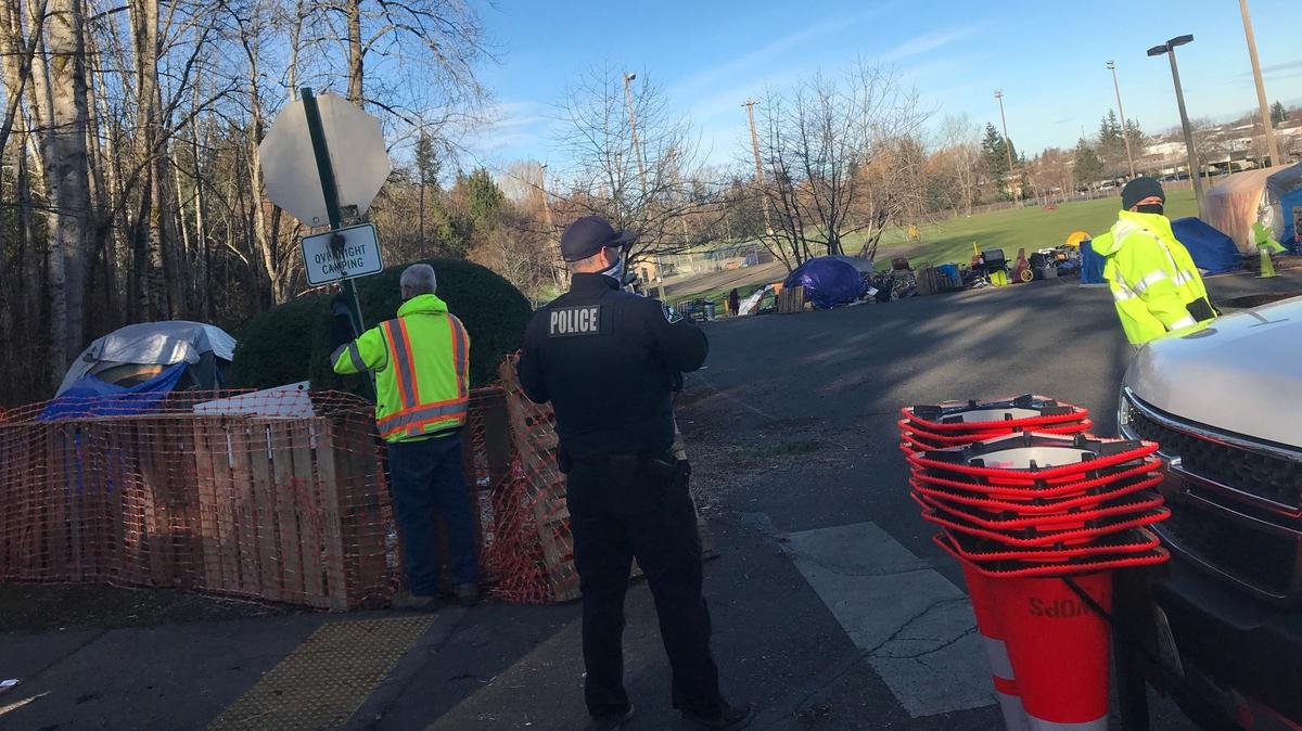 City workers put up news signs Tuesday, March 9, near the homeless camp at Frank Geri Softball Fields in the Puget neighborhood of Bellingham.