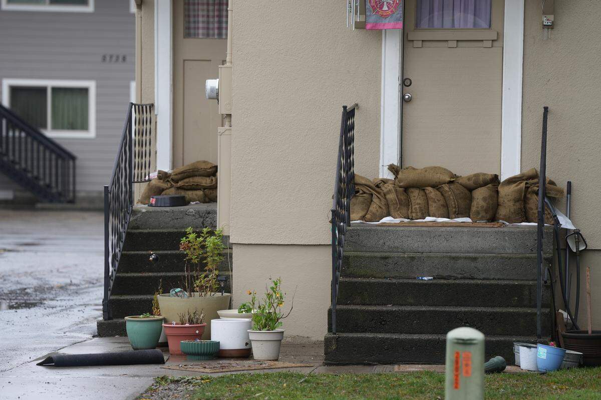 Sandbags are stacked outside the door to a home in the Nooksack River flood zone Dec. 12 in Ferndale.