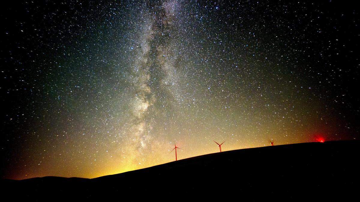 The Milky Way lights up the sky in August 2016 near wind mills north of Dayton. Millions of homes, buildings and landmarks will go dark for at 8:30 p.m. local time Saturday as part of the annual Earth Hour.