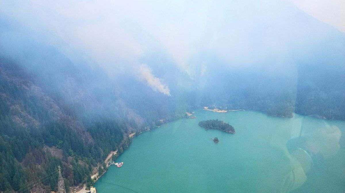 Smoke from the Sourdough Fire rises over Diablo Lake and Diablo Dam on Saturday, Aug. 5, 2023, near Diablo, Wash.