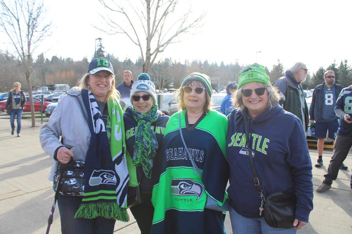 Friends gather for the Seahawks rally Friday at Civic Stadium in Bellingham.