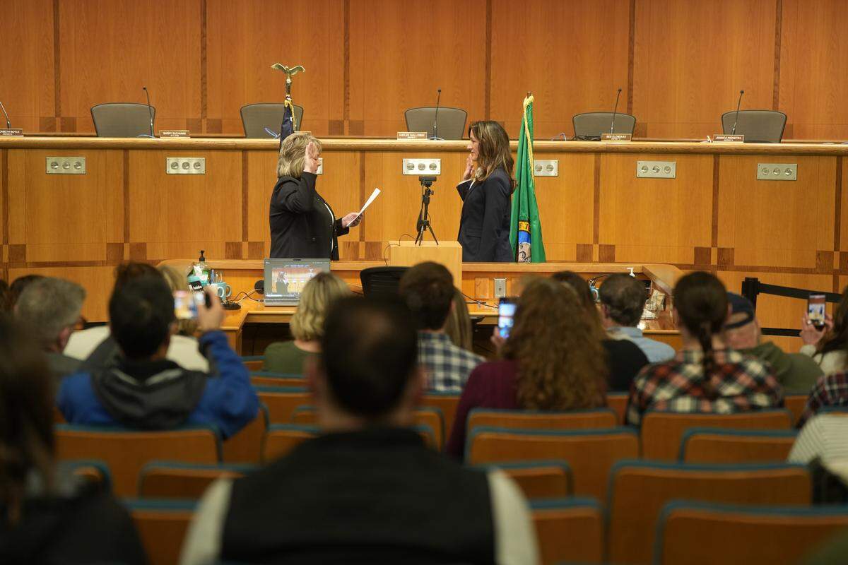 Whatcom County Council member Elizabeth Boyle (right) participates in the oath of office ceremony Jan. 12. Her term ends in January 2030.