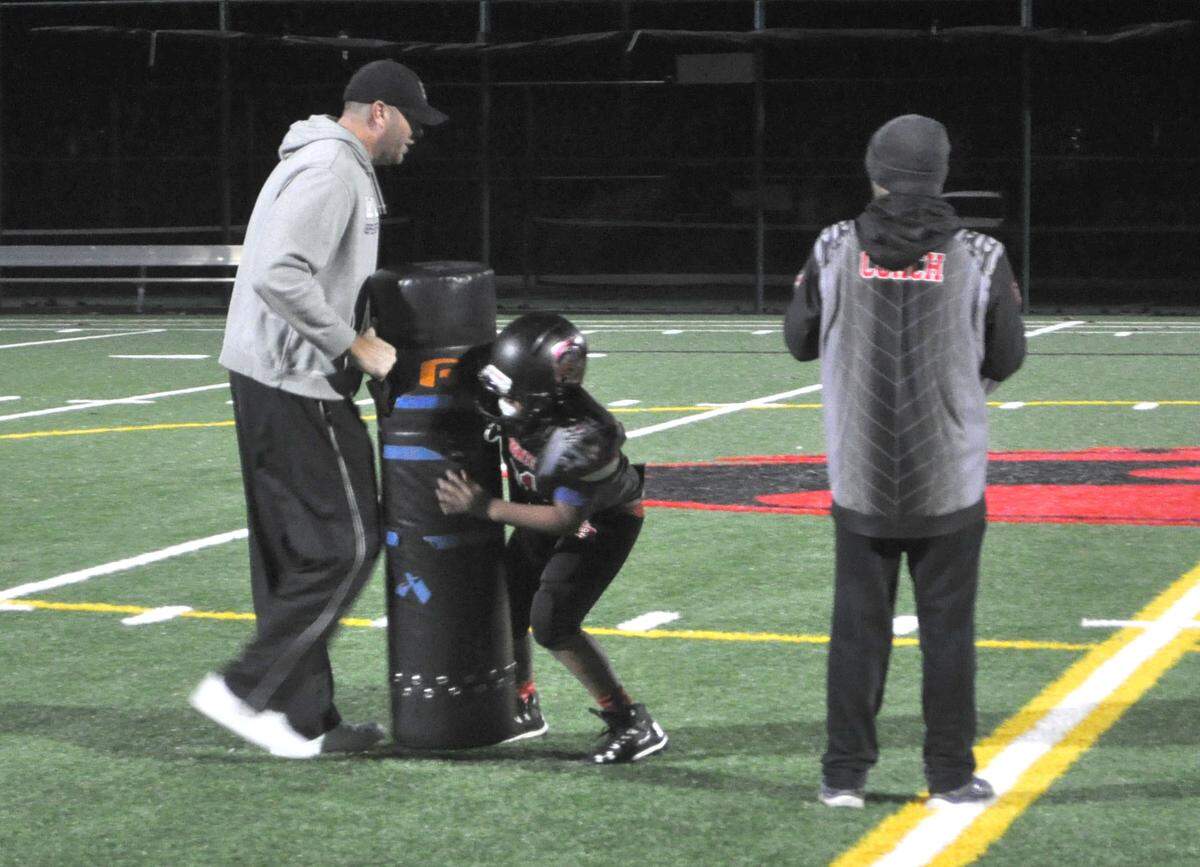 The Bellingham Knights youth football team goes through practice drills Wednesday at Bellingham High School. The Knights, who are made up of 9- and 10-year-old players, head to Canton, Ohio, this week to play in the 2018 World Youth Championship.