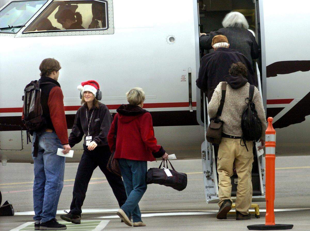 Passengers board a plane at Bellingham International Airport on Christmas Eve in 2004. The TSA expects a record number of travelers are expected during the 2018 Christmas and New Year travel season, including at Bellingham International Airport, which is expecting to see a 1.25-percent increase.