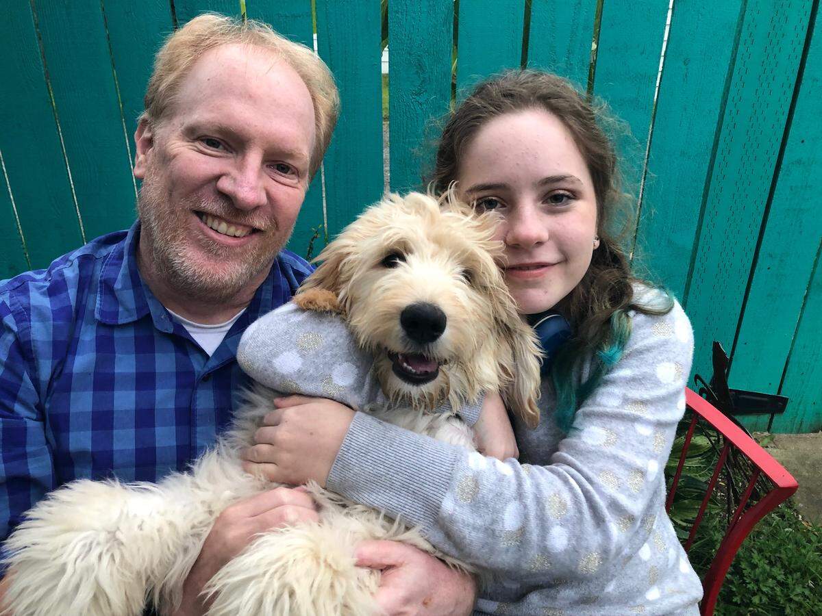 Reporter Dave Gallagher, with Stan the Goldendoodle and daughter Ella.