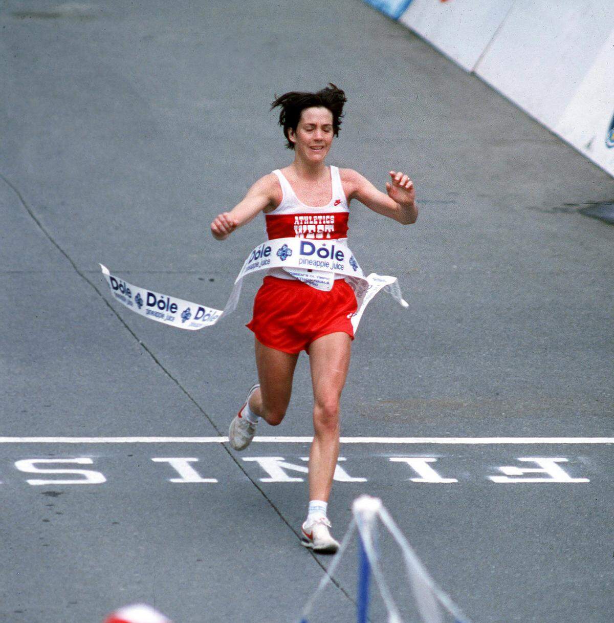 Joan Benoit Samuelson crosses the finish line to win the 1984 Olympic marathon trials in Olympia.