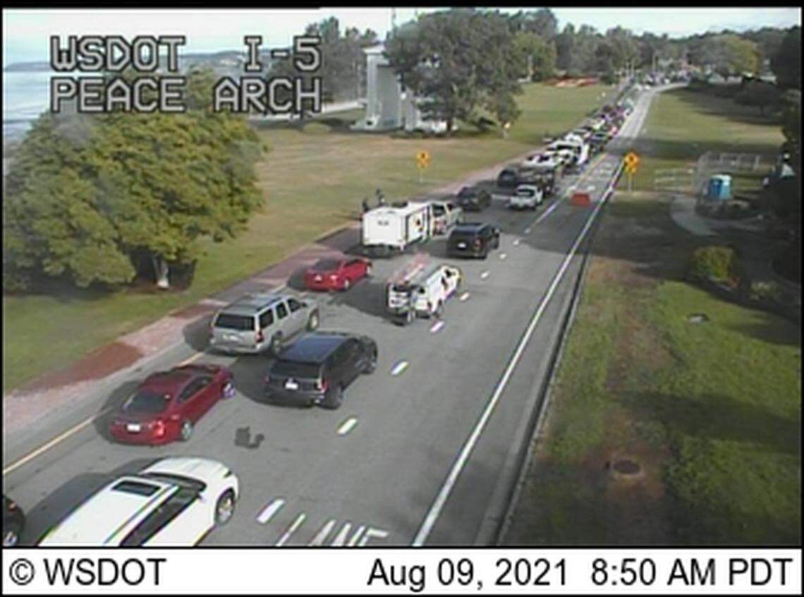 Cars wait to cross into Canada at the Peace Arch border crossing in Blaine, Wash., Monday, Aug. 9. Canada began allowing COVID-vaccinated U.S. citizens to cross the border for non-essential travel on Monday.