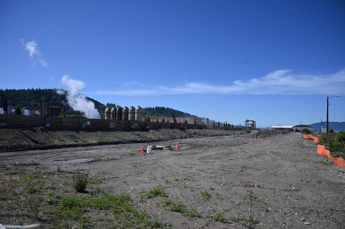 The former Georgia-Pacific pulp mill digesters are seen in the distance from Waypoint Park at the future site of condominiums to be built by developer Harcourt on the Bellingham waterfront.