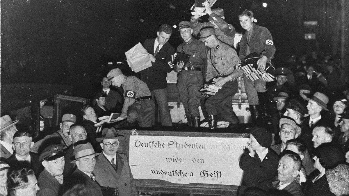 Nazi students unload confiscated materials for a public book burning in Berlin in an undated historical photo. The banner on the back of the truck reads: “German students march against the un-German spirit.”