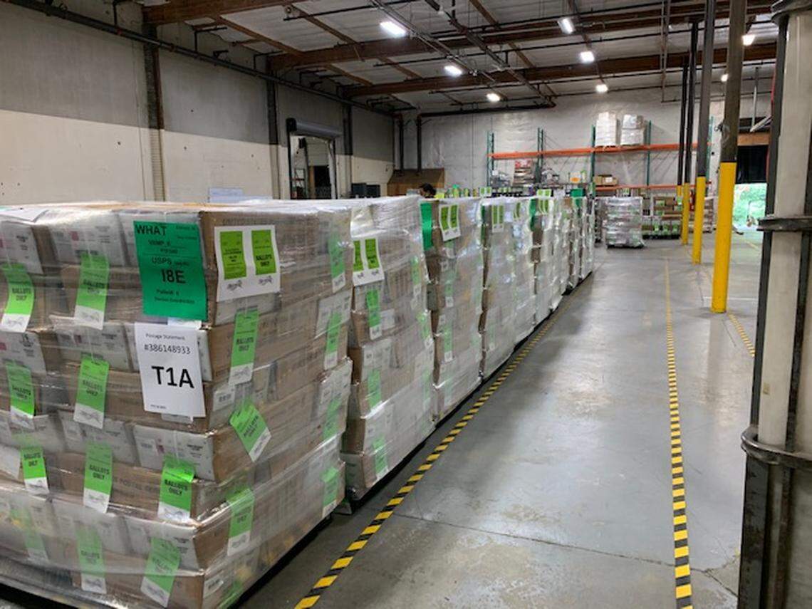 Pallets containing 150,000 ballots bound for Whatcom County, Wash., are stacked at K&H Election Services’ shipping facility in 2020 in Seattle.