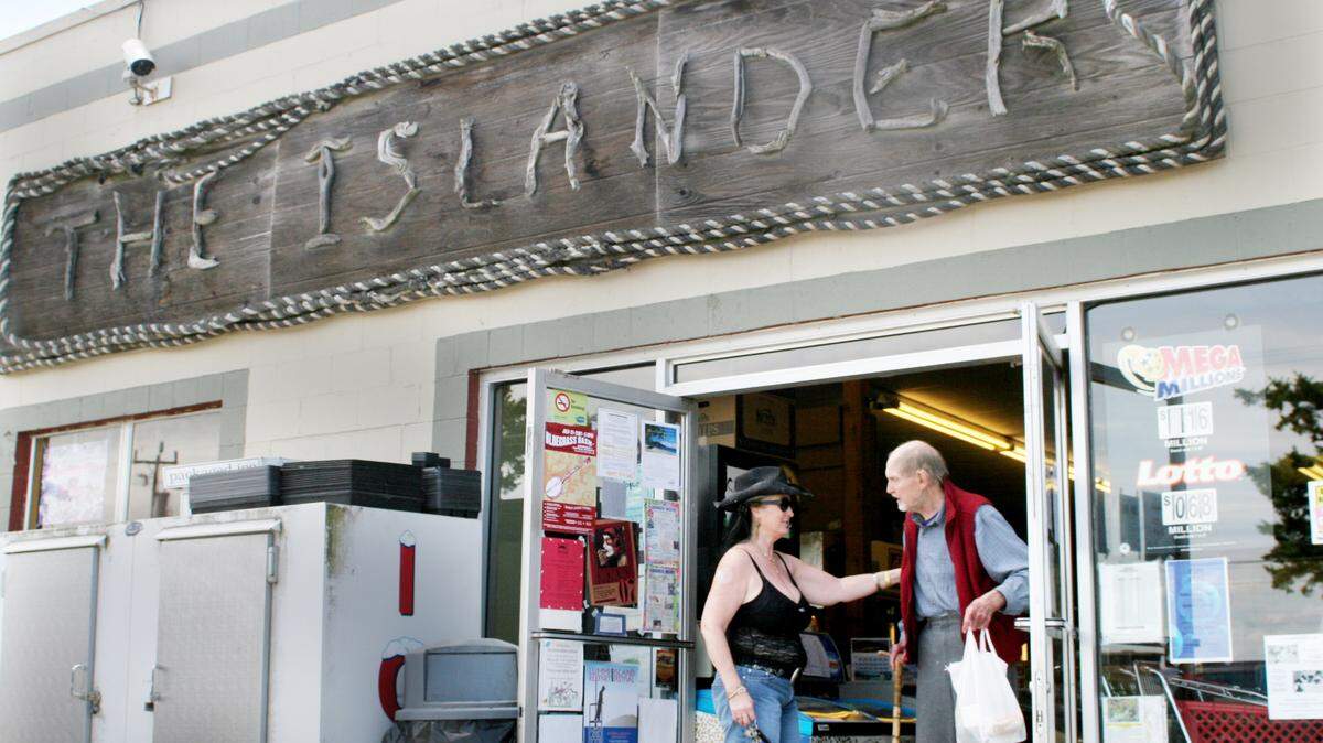 Customers at The Islander store on Lummi Island greet one another in 2007. The store has been open since 1989, but without the normal summer revenue flowing in during COVID-19 closures, owner Brad O’Malley said the store won’t be able to stay open this winter. Neighbors have started a GoFundMe account to help.