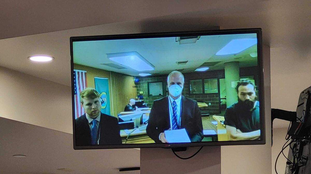 Per Olaf Johansson, 44, (right), stands next to his public defense attorneys Scott Schmidt (left) and Kevin Flannery (far left) as he makes his first appearance in Whatcom County Superior Court Tuesday, April 25, 2023. Johansson is accused of stabbing three family members, killing one of them, in December 2010.