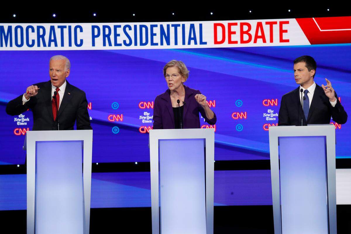 Democratic presidential candidate former Vice President Joe Biden, left, Sen. Elizabeth Warren, D-Mass., center and South Bend Mayor Pete Buttigieg speak during a Democratic presidential primary debate hosted by CNN/New York Times at Otterbein University, Oct. 15, 2019, in Westerville, Ohio.