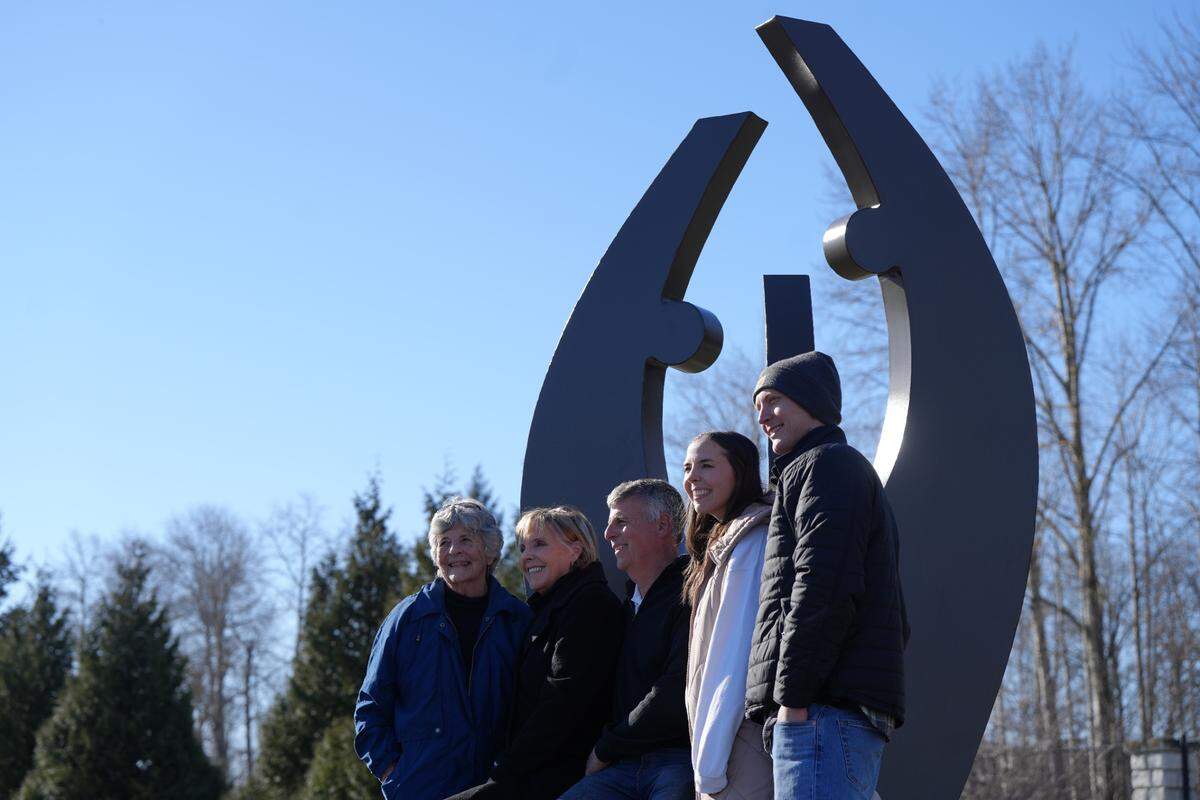 Robin and Chris Larson, second from left and third from left, respectively, pose for a photo with family members.