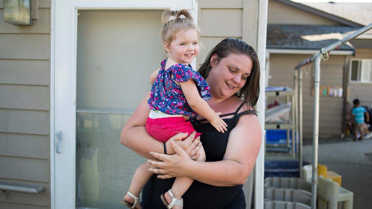 Ashley Wright, right, picks up her daughter Tru Davidson from Promise Day Care on Thursday, Aug. 10, in Bellingham. 