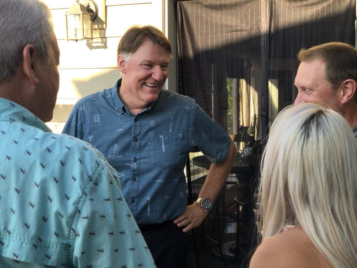 Whatcom County Executive candidate Tony Larson interacts with friends at on the deck of his home in the Geneva neighborhood on primary election night Aug. 6.