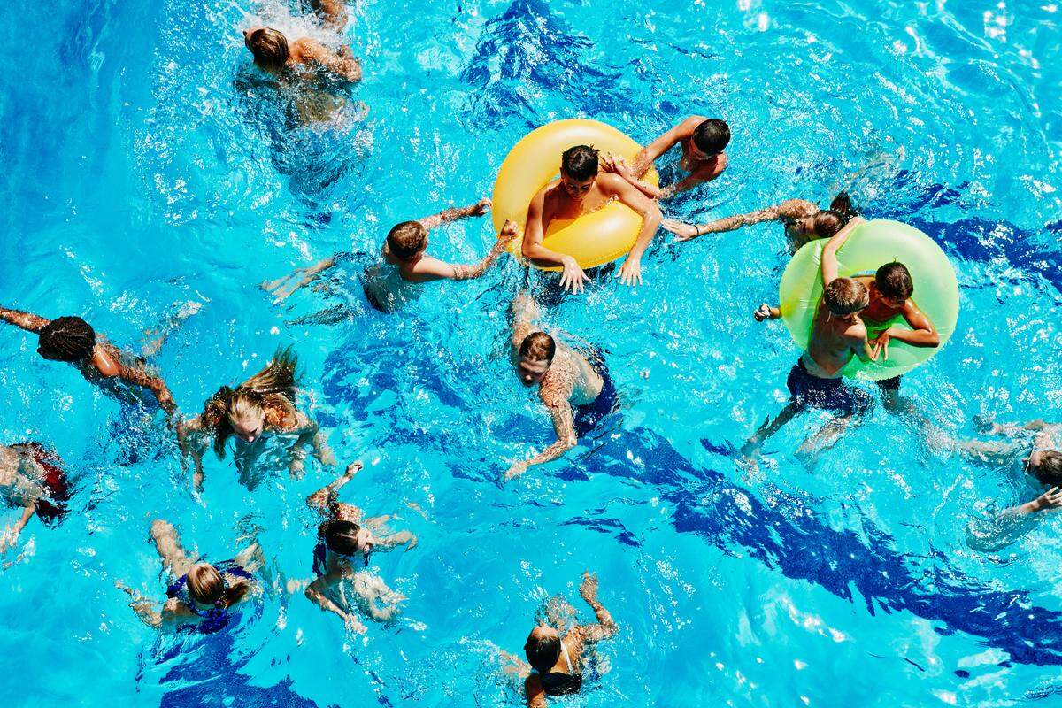 Group of kids playing together in pool.
