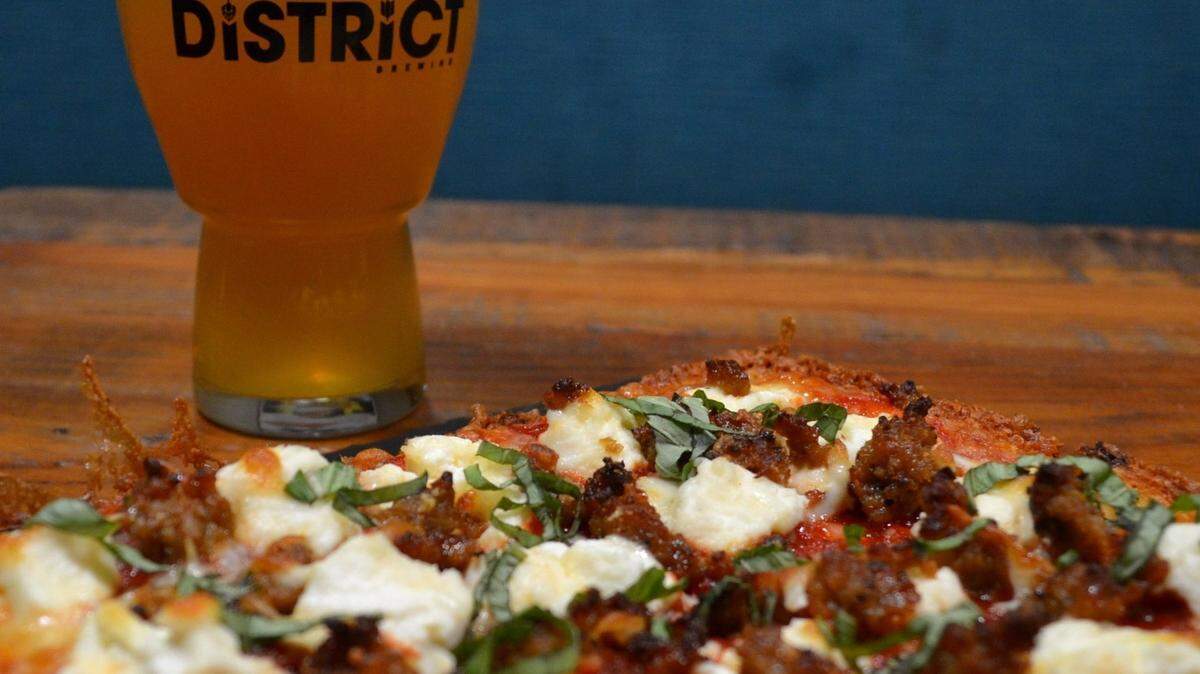 A pizza and beer from District Brewing Co., a brewery started in Mount Vernon, Washington with locations in Mount Vernon, Ferndale and Lynden.