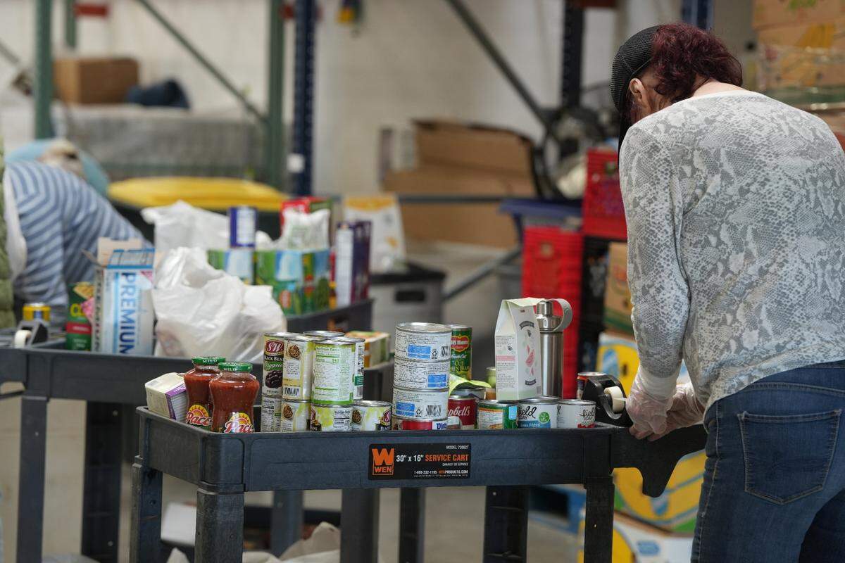 Volunteers sort through donated food at the Bellingham Food Bank on April 24, 2025, in Bellingham, Wash.