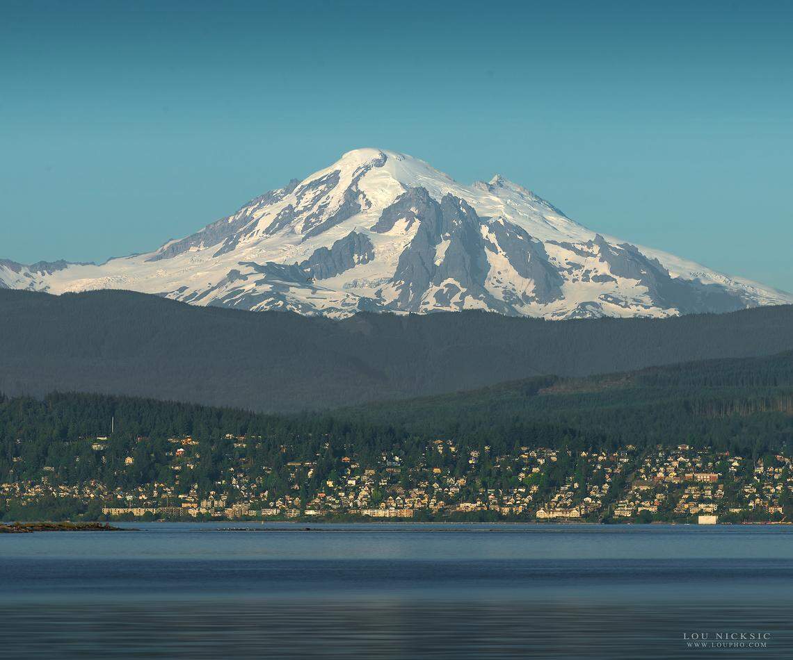 Mt. Baker rises behind the City of Bellingham in a view from Lummi Shore Road in July 2018. Whatcom County’s volcano has two seismographs to monitor earthquake activity, said Carolyn Driedger of the USGS Cascades Volcano Observatory in Vancouver, Wash. “We have a lot to be done in regard to increased monitoring,” Dreidger said.”It’s a long haul and we’re making a lot of progress.”