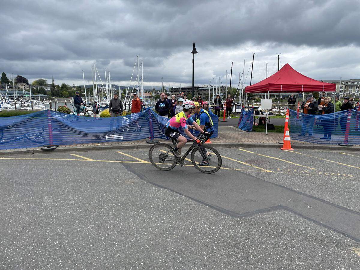Birch Equipment cyclocross rider hands off the timing device at Zuanich Park to the team’s kayaker, who was first in the water for the final leg of the Ski to Sea race Sunday, May 29.