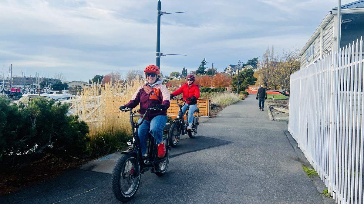 E-bike riders enjoy a sunny day on a trail along Squalicum Harbor in Bellingham.