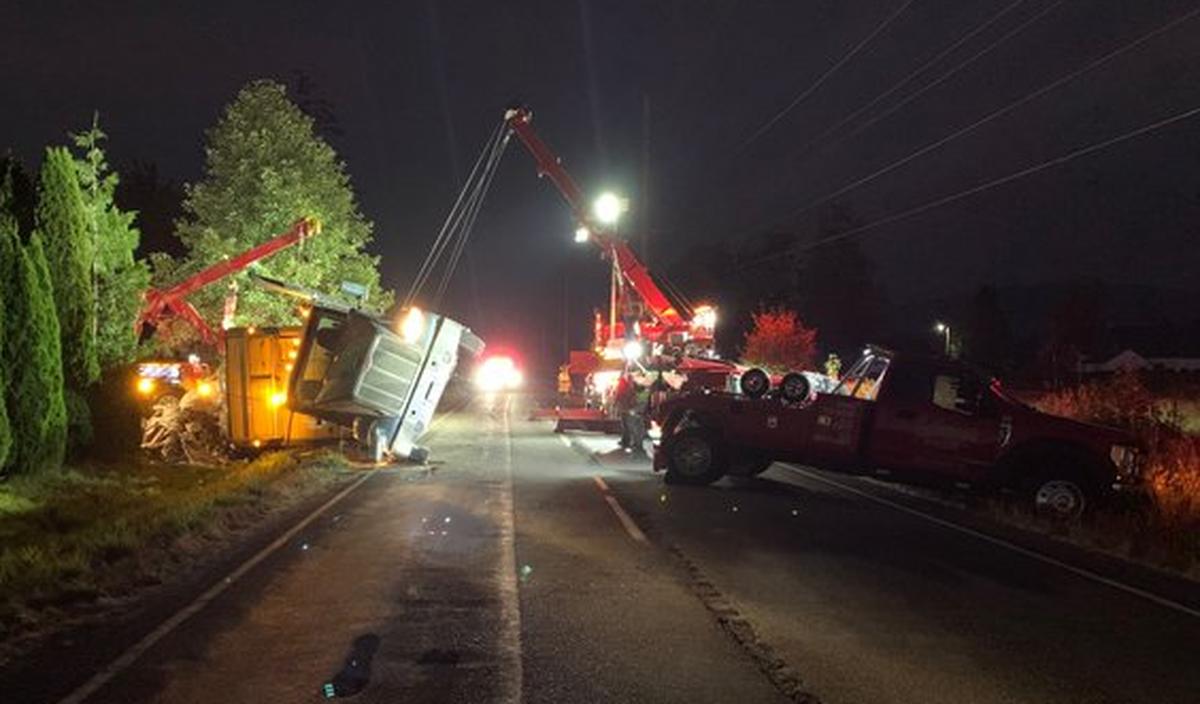It took three heavy-duty tow trucks and more than seven hours to clean up after a semi-truck carrying garbage rolled Thursday evening, Aug. 18, along State Route 546 in Whatcom County.