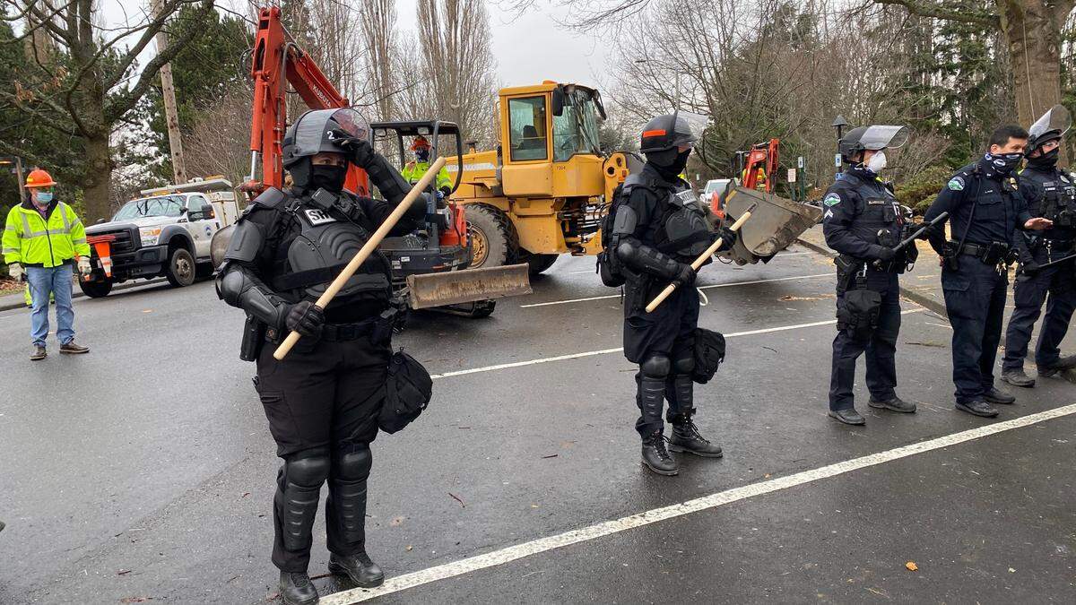 Police and city crews prepare to remove the Camp 210 homeless encampment from the City Hall and library lawns on Lottie Street in downtown Bellingham Thursday, Jan. 28.