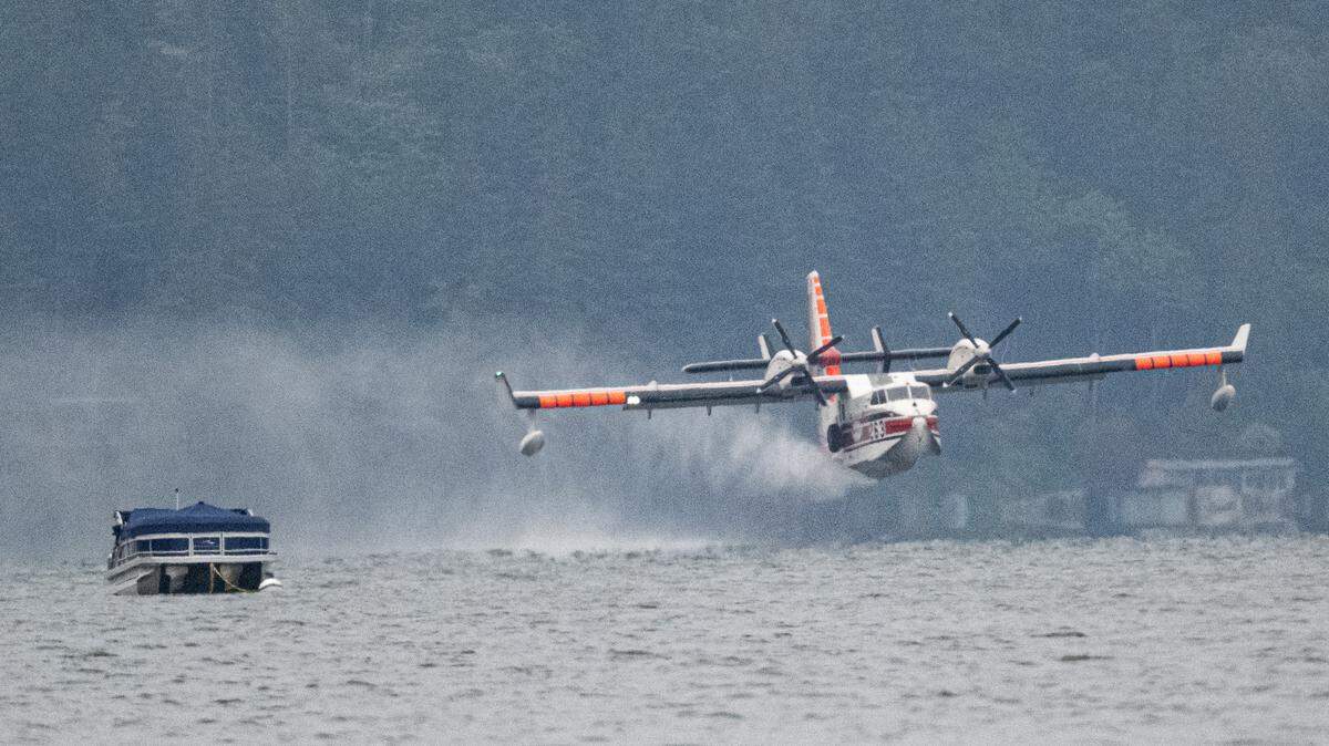 A firefighting aircraft refills its water tank by scooping water from Lake Whatcom near the Sudden Valley marina on Tuesday.