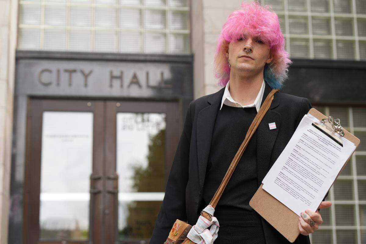 Local transgender rights activist Selene Etheredge holds a draft resolution proposing Bellingham define itself as a trans sanctuary city in front of City Hall on June 4.