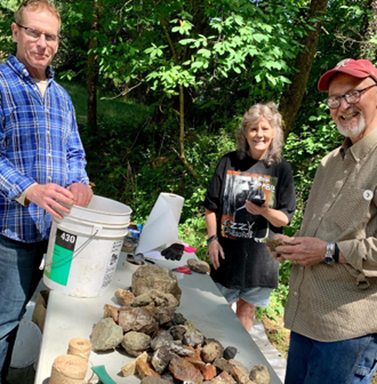 Washington Agate and Mineral Society President Jim Sachet (right) sets up a display of rocks and minerals with other club members.