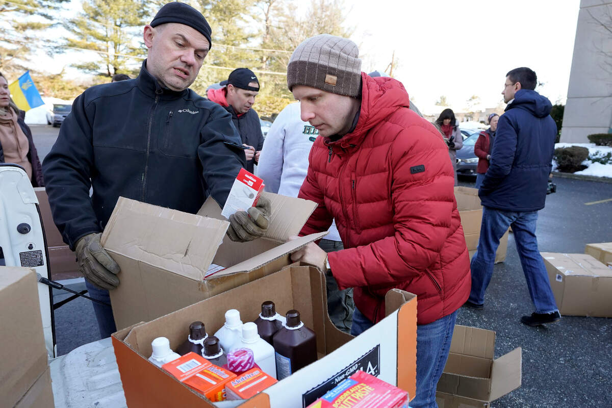 Volunteers Slavko Oleinik, of Framingham, Mass., left, and Victor Pishuk, of Newton, Mass., place medical supplies in boxes for shipment to Ukraine, Wednesday, March 2, in Woburn, Mass. Amid the conflict triggered in Ukraine by the Russian invasion, many aid organizations are raising funds to help those impacted by the conflict.