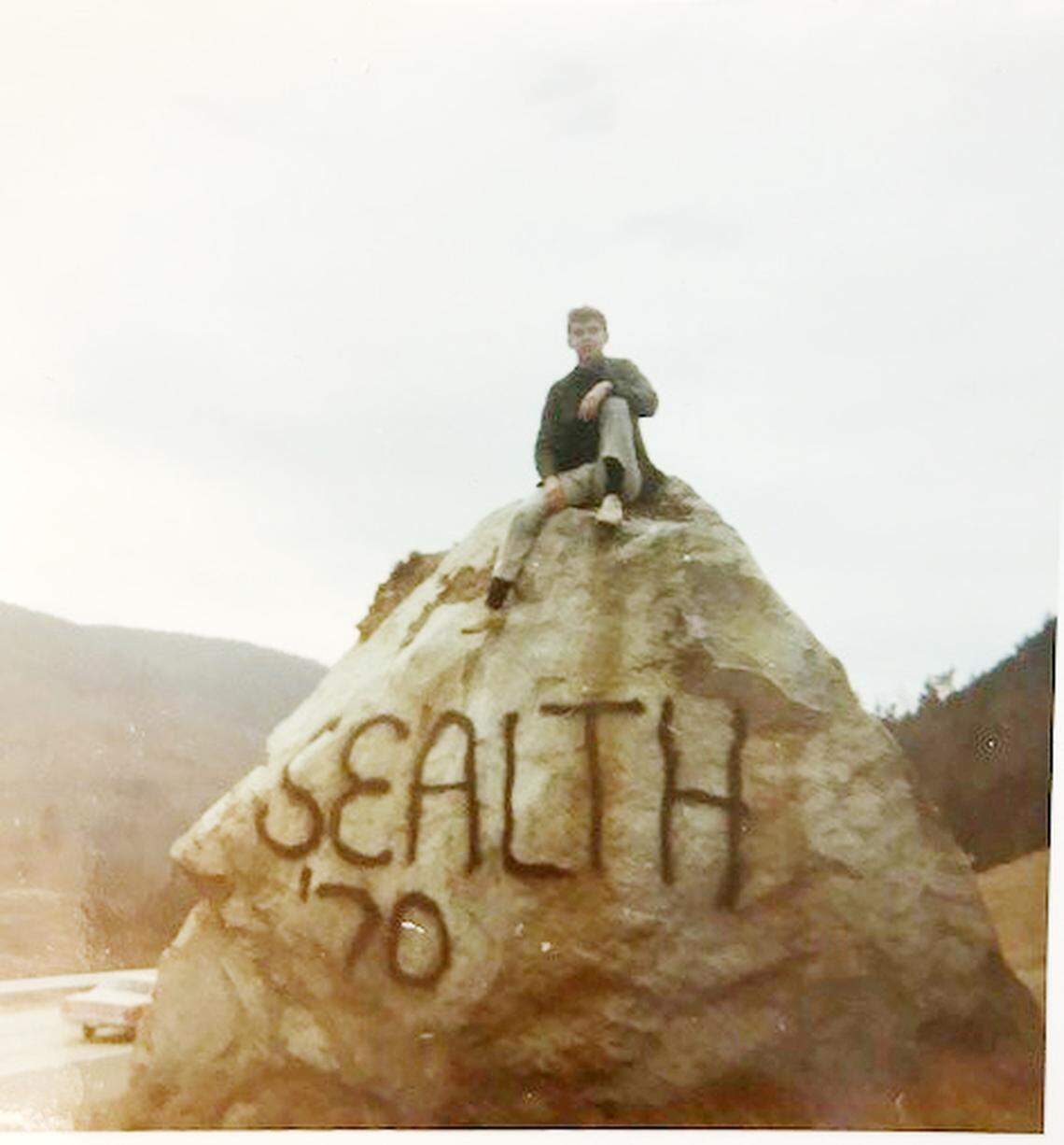Dan McNamara, then 17, sits on top of "the rock" off northbound Interstate 5 near Bellingham that he painted in August 1969.