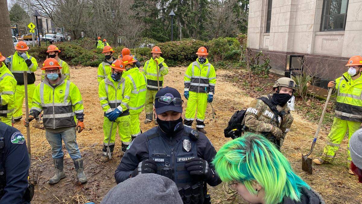 Police and city crews prepare to remove the Camp 210 homeless encampment from the City Hall and library lawns on Lottie Street in downtown Bellingham Thursday, Jan. 28.