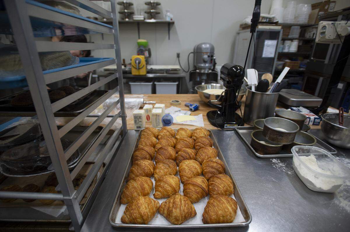 Baked croissants wait to be put on display and sold at the Iron Rooster Bakery in Fairhaven.