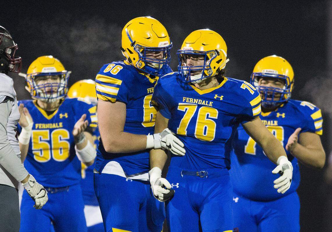 Ferndale’s Geirean Hatchett (66) celebrates with Mikhail Varetskiy after stopping Bethel’s running back for a loss in the first round of Class 3A state playoffs on Friday, Nov. 10, 2017 at Civic Field in Bellingham.