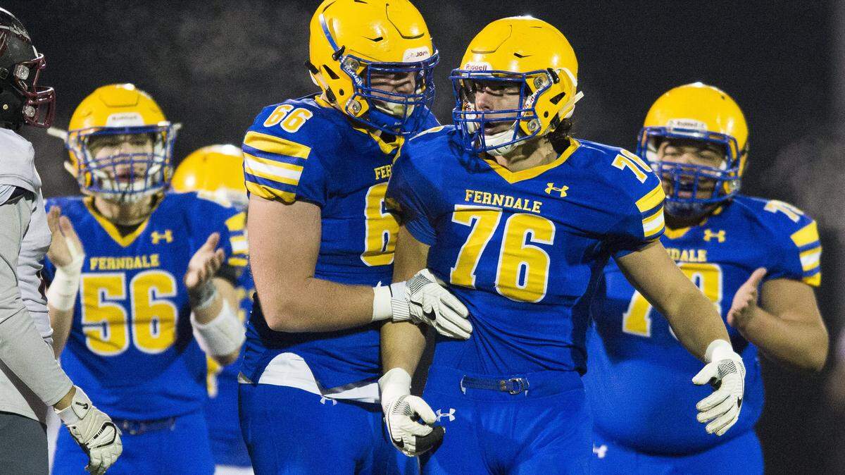 Ferndale’s Geirean Hatchett (66) celebrates with Mikhail Varetskiy after stopping Bethel’s running back for a loss in the first round of Class 3A state playoffs on Friday, Nov. 10, 2017 at Civic Field in Bellingham.