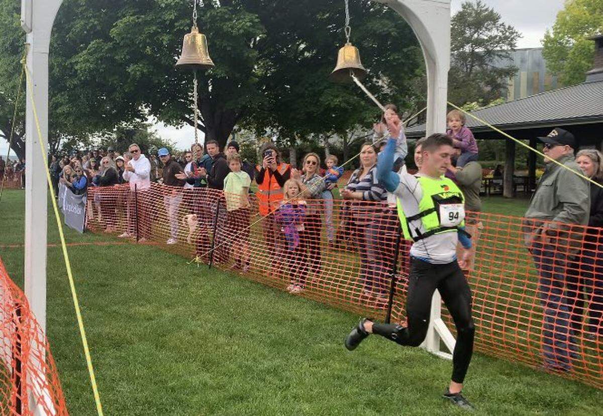 Aaron Small rings the bell for team COMPASS at Marine Park in Fairhaven for the Ski to Sea race Sunday, May 29.