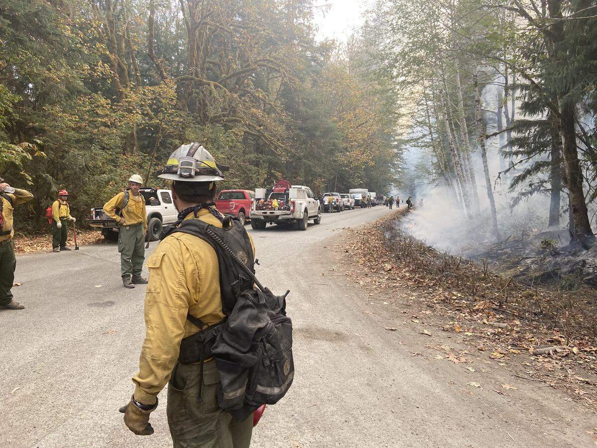 Crews watch an area of the Bolt Creek fire, one of several wildfires that continue to burn in the region and contribute much of the smoke in the area. The fire will continue to produce smoke as it burns to the north into Wild Sky Wilderness in the Mount Baker-Snoqualmie National Forest, according to an update Thursday, Oct. 13.