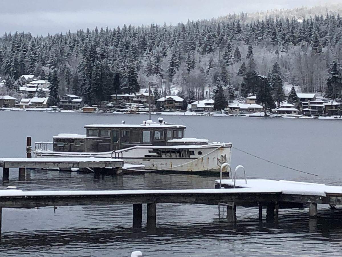 Snow covers the docks and trees around Lake Whatcom in Bellingham Tuesday.