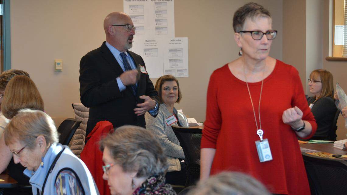 Chief Deputy Auditor Diana Bradrick, right, listens to an elections worker’s question Monday during the recount at the County Courthouse. At left is Bellingham lawyer Brett Bonner, an observer representing state Sen. Doug Ericksen.